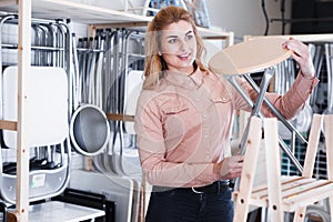 Woman looking for tabouret in salon