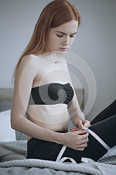 Woman looking at tape-measure