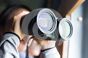 Woman looking though binocular photo