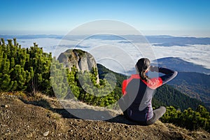 Woman looking to the horizon in the mountains