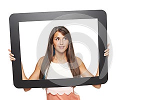 Woman looking to side through tablet frame