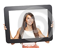 Woman looking to side through tablet frame