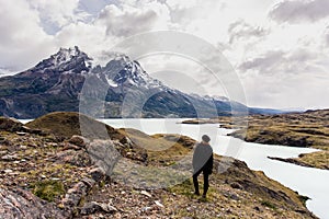 woman looking toward awesome view of Torres del Paine mountain range