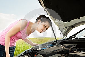 Woman Looking Under Hood Car