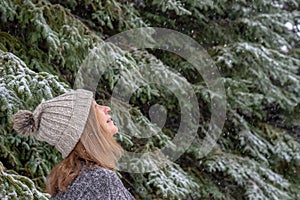 Woman looking up at snow falling