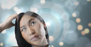 Woman looking up with sparkling background