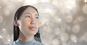 Woman looking up with sparkling glamorous background