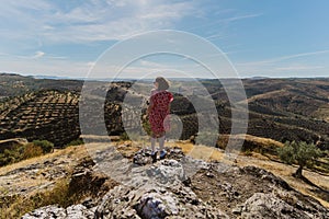 Woman looking from the viewpoint of the castle of Melhor, Portugal to a green landscape photo