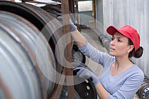 Woman looking at wheel rims in racking