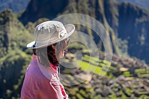Woman looking at World Heritage site in Cusco Region