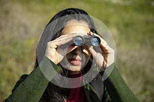 Woman looks through the binoculars