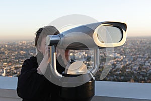 Woman looks through binoculars