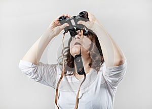 Woman looks through binoculars