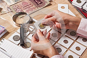 Woman looks at the collector s coin