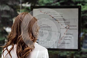 Woman looks at map of public transport route