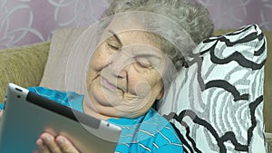 Woman looks at pictures using a digital tablet