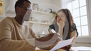 Woman looks at realtor telling details of apartment purchase