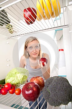 Woman Looks into Refrigerator