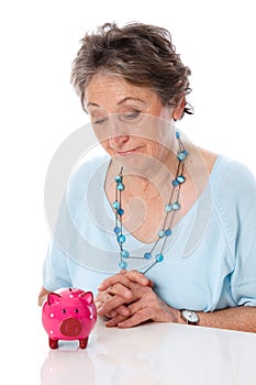 Woman looks sadly at savings - elder woman isolated on white background photo