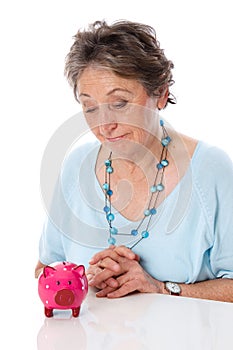 Woman looks sadly at savings - elder woman isolated on white background