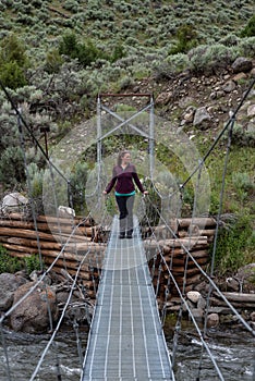 Woman Looks to Side While Standing on Bridge