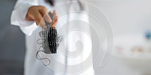 Woman losing hair on hairbrush in hand, soft focus