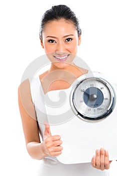 Woman losing weight with scale