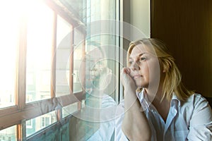 The woman lost in thought looking out the window.