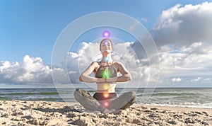 Woman in lotus position meditates on beach. Concept of self-healing, self-knowledge. Seven chakras