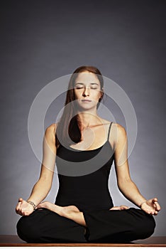 Woman in lotus posture (Padmasana) photo