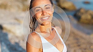 Woman lovely looking at camera with smile and enjoying summer vacation on beach