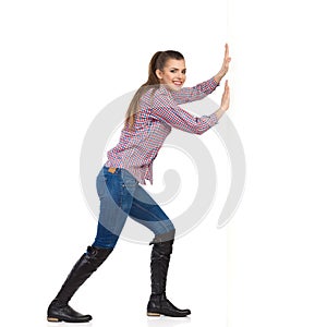 Woman In Lumberjack Shirt Pushing Wall