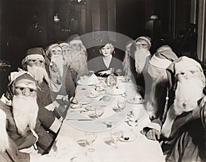 Woman lunching with twelve Santa Clauses