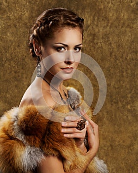 Woman in luxury golden fox fur coat, retro style