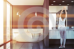 Woman in luxury gray bathroom interior