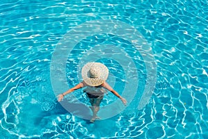 Woman in luxury spa resort near the swimming pool