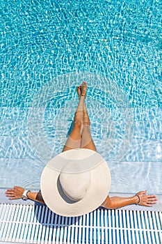 Woman in luxury spa resort near the swimming pool