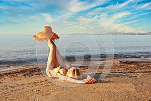 A woman lying on the beach near the ocean