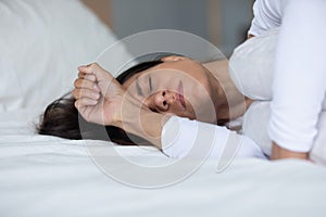 Woman lying in bed closed eyes crying feels miserable