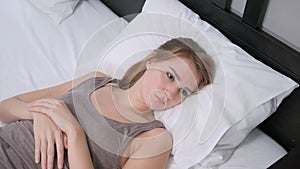 Woman Lying in Bed Feeling Uncomfortable, Unrest photo