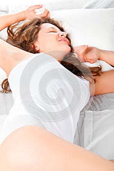 Woman is lying in bed at morning