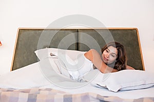 Woman lying on the bed smiling