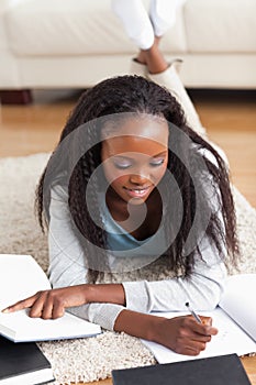 Woman lying on carpet in living room