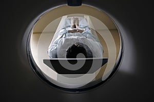 Woman Lying In CAT Scan Machine