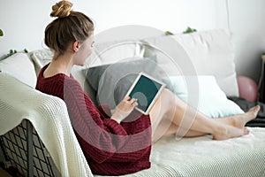 Woman lying on the couch in the living room . close up back view photo