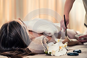 Woman lying down during Asian anti-aging treatment