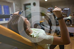 Woman doing exercises with dumbbells