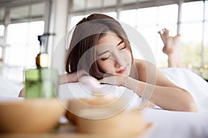 Woman Lying Down on Massage Bed withing for Spa Treatment