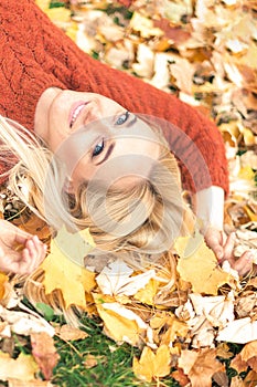 Woman lying down on yellow leaves