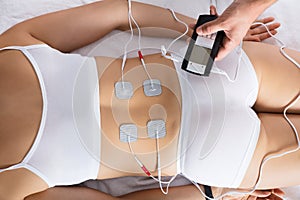 Woman Lying With Electrodes On Her Back